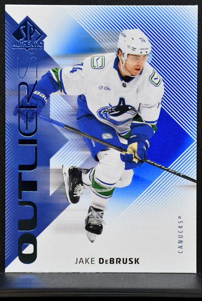 2025-26 SP Authentic Outliers Blue Jake DeBrusk O-21 Vancouver Canucks 1983